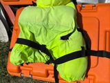 a large orange case with a sleeping bag on top of it