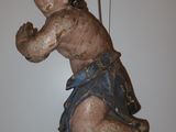 a statue of a child hanging on a string