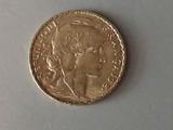 a close up of a gold coin with a woman ' s face on it