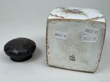 a small black object next to a small black object