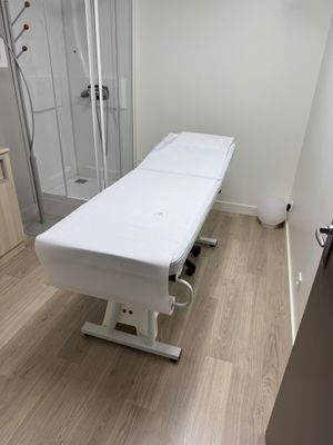 a room with a table and a shower in it