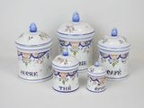 five blue and white canisters with the words the cafe