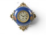 a blue and gold clock hanging on a wall