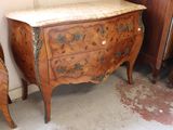 a small chest of drawers with a marble top