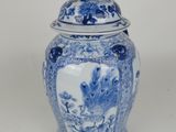 blue and white ginger jar with a lid with a bird on the lid