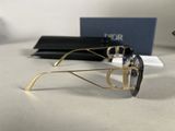 sunglasses on a table with a box and a pair of glasses