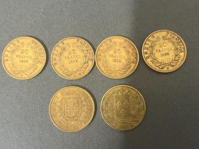 a group of five gold coins sitting on top of a table