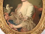 portrait of a woman holding a bird in a gold frame