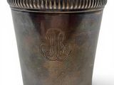 an antique silver cup with a monogram on the side
