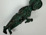 an old bronze figurine of a man with a hat on his head