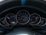 a close up of a car dashboard with gauges and a steering wheel