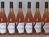 six bottles of wine are lined up on a table
