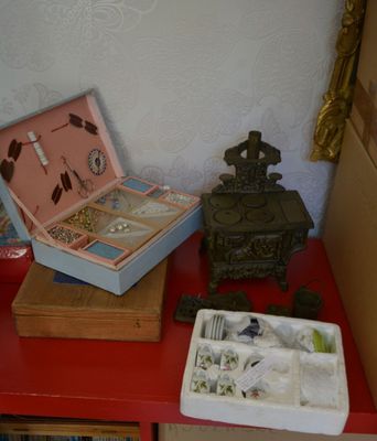 a red table with a box of jewelry and a box of jewelry on it