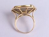 an image of a gold ring with a diamond in the middle