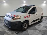 the white van is parked in a large room with a checkered floor