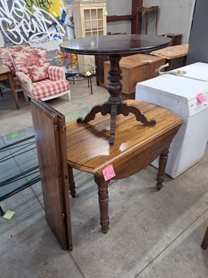 a table with a chair and a refrigerator in front of it