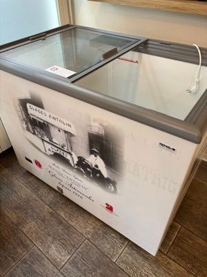 an ice cream machine sitting on top of a wooden floor