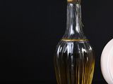 a bottle of perfume next to a small bottle of perfume