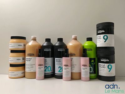 de nombreux flacons de produits capillaires de différentes couleurs posés sur une table