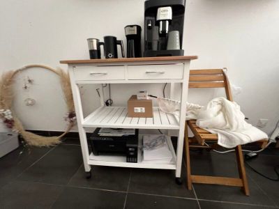 a small kitchen with a coffee maker on a small table
