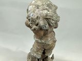 statue of a boy on a pedestal with a hat on his head