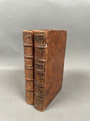 a pair of old books sitting on top of each other