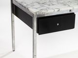 a marble top desk with a black drawer underneath it
