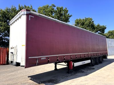a semi trailer that is parked in a parking lot