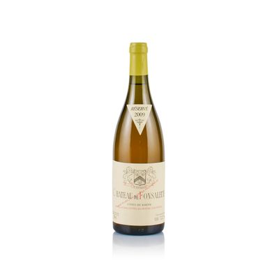 a bottle of wine sitting on top of a white table