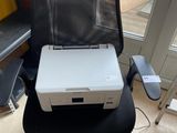 a white printer sitting on top of a black chair
