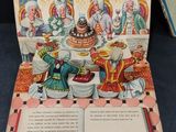 an open book with a picture of a christmas scene on it