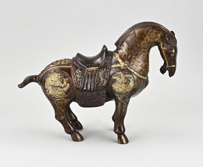 bronze figurine of a horse with a saddle on it ' s back