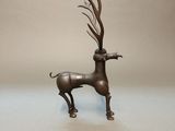 bronze sculpture of a deer with antlers on it ' s head