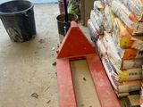 a fork lifter that is next to a pile of food