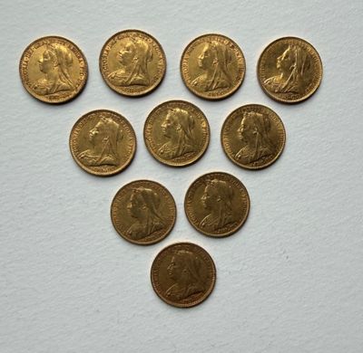 a bunch of gold coins sitting on top of a white surface