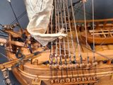 a wooden model of a ship on display on a table