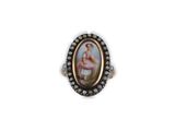 a picture of a ring with a picture of a ballerina