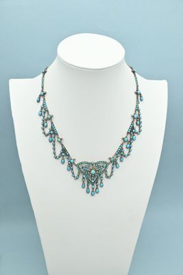 a necklace with blue beads on a white mannequin