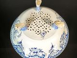 a blue and white porcelain bowl with birds on it
