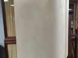 a white couch sitting on a black stand in a room