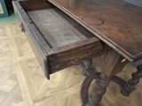 a wooden table with a drawer on top of it