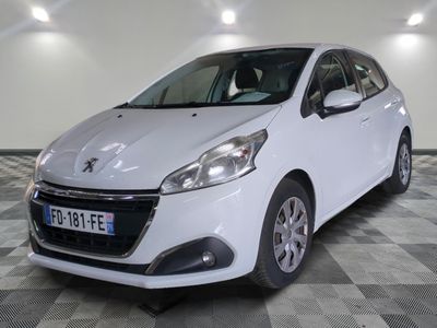 the small white car is parked in a large room