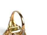 yellow gold ring with diamond accents on a white background