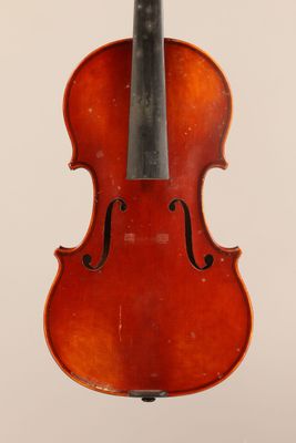 an old violin with a bow hanging from it ' s back