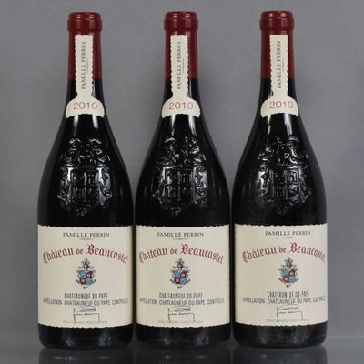 three bottles of red wine sitting on top of a table