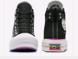 a pair of black converses that are on a white surface