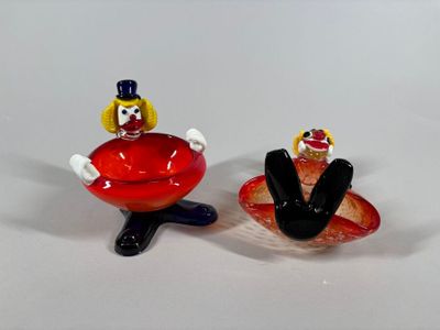 two figurines of a man and a woman sitting on a plate