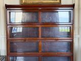 a picture of a dresser in a room with a painting on the wall