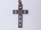 a close up of a cross on a white surface with a white background