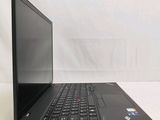 the back of a laptop computer sitting on top of a white table